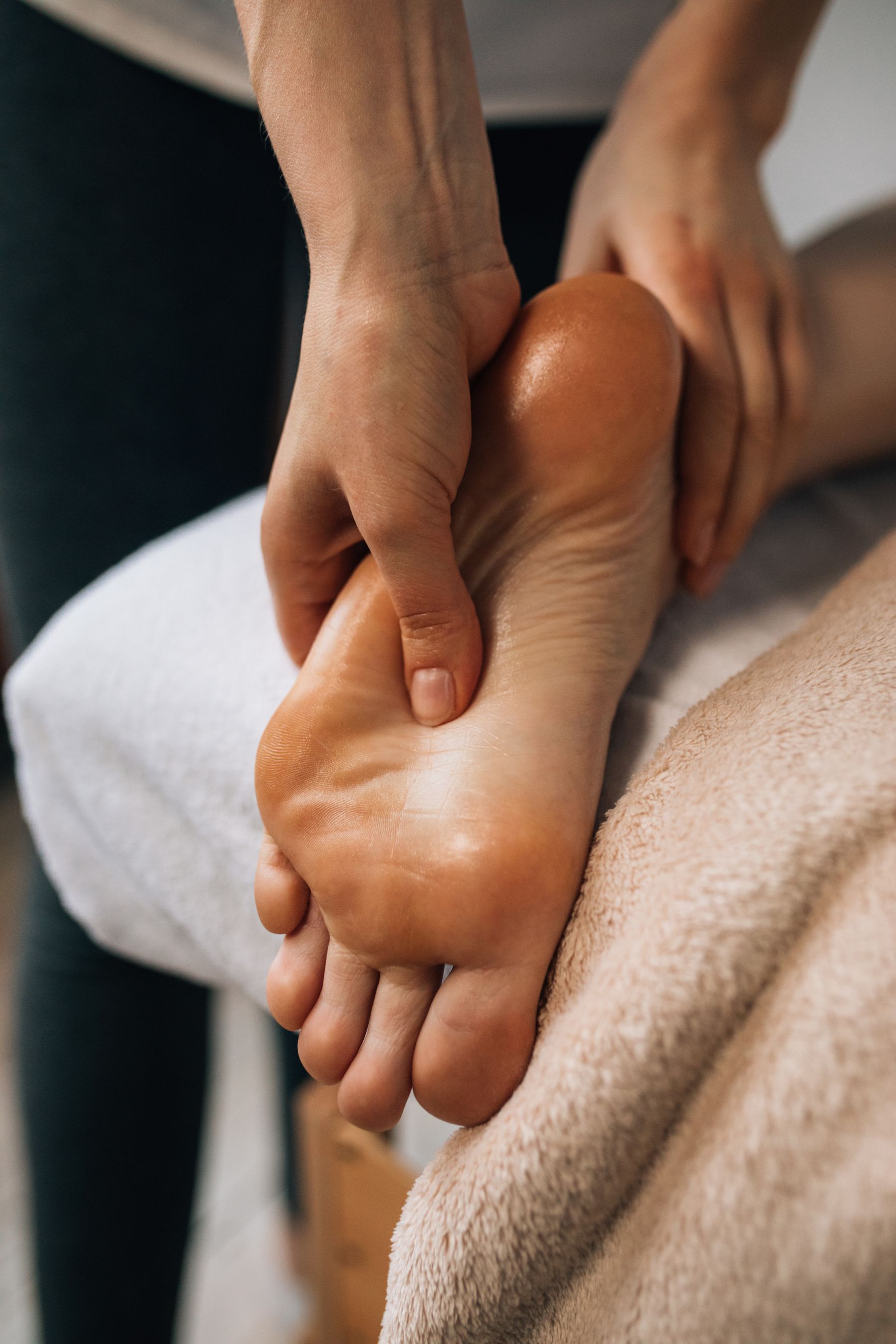 Close-up of hands working on a foot during a treatment