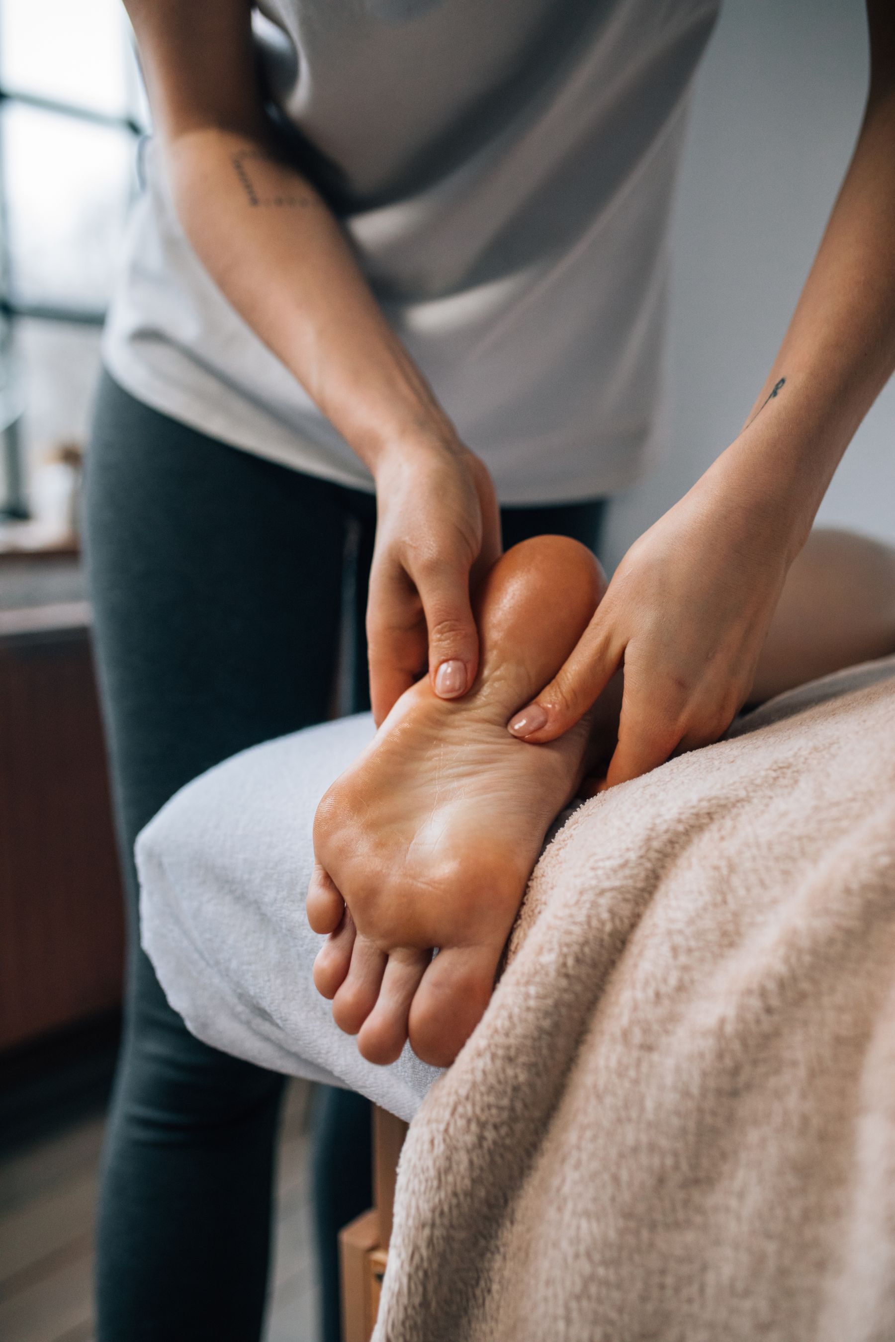 Close-up of hands massaging a foot