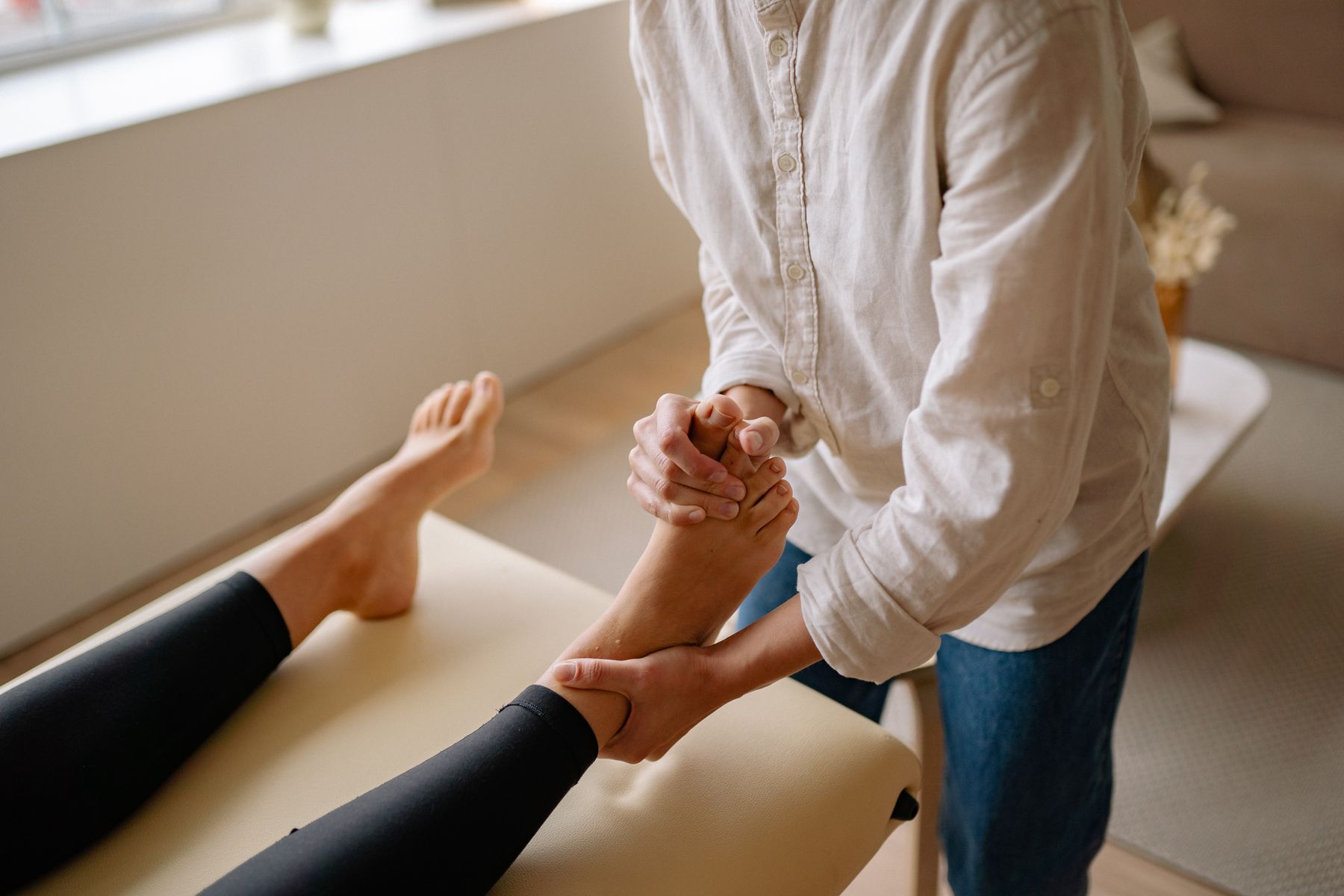 Close-up of hands massaging a foot